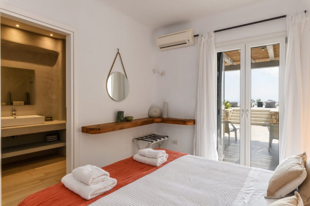 Cozy bedroom with a terrace, Mykonos deluxe villa for rent.