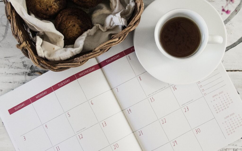 A calendar with cookies and tea