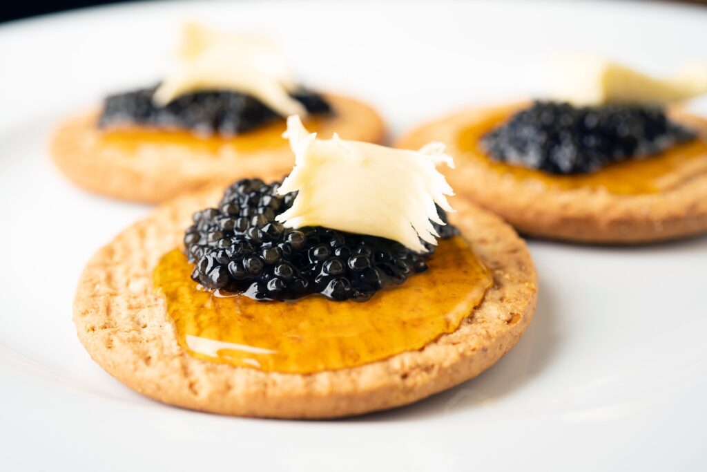 black caviar and cheese on crackers