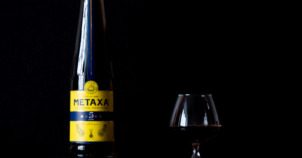Bottle of Metaxa and a brandy glass 
