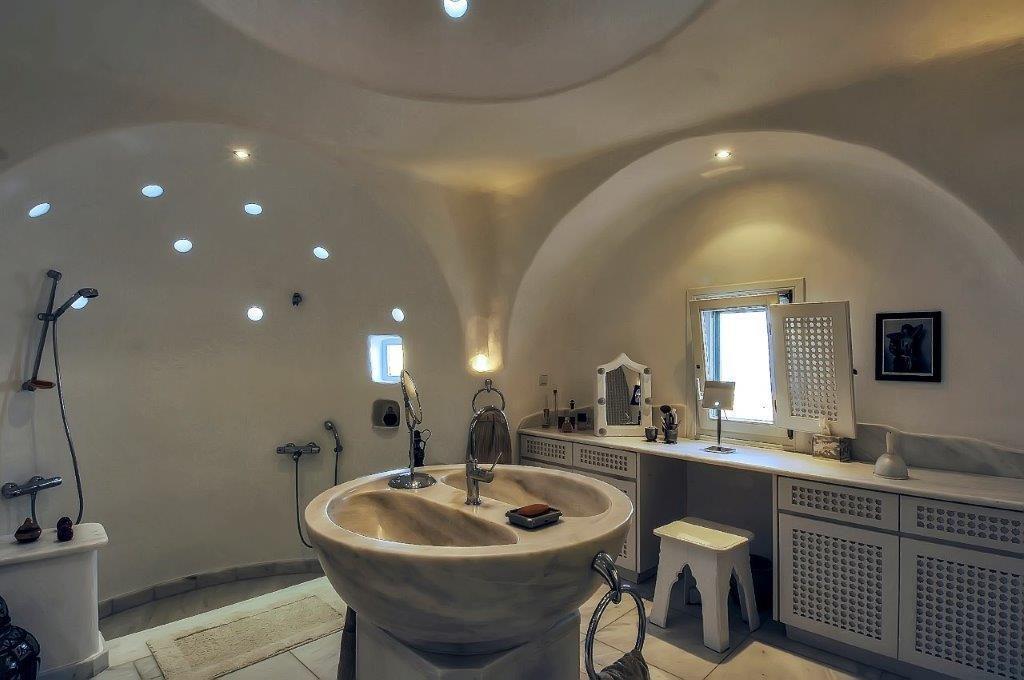modern designed bathroom with shower and unique ceramic sink