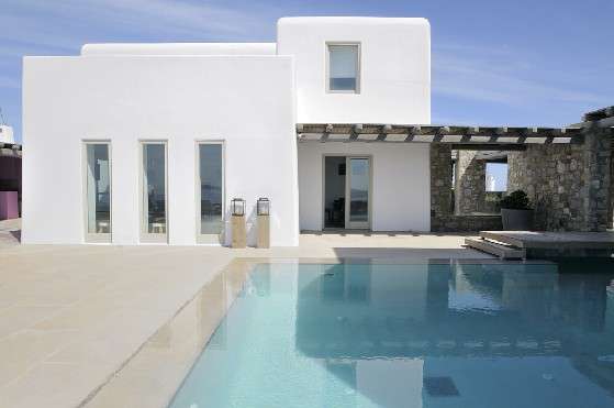 Villa Elizabeth, Aleomandra, Mykonos, exterior, white building, porch, stone walls, swimming pool, blue sky