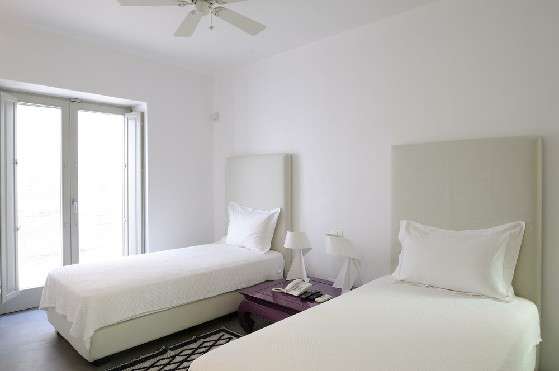 Villa Elizabeth, Aleomandra, Mykonos, bedroom, double bed, pillows, night stand, night lamps, balcony doors