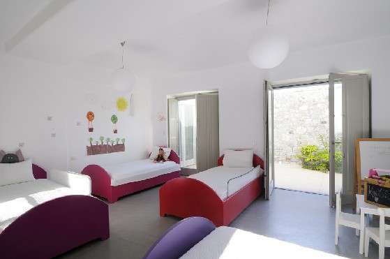 Villa Elizabeth, Aleomandra, Mykonos, children bedroom, four-bed room, desk, chairs, wall decoration, balcony doors, plants, chest