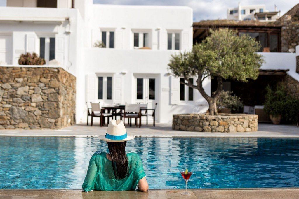 Woman sitting in a pool at villa Galactica