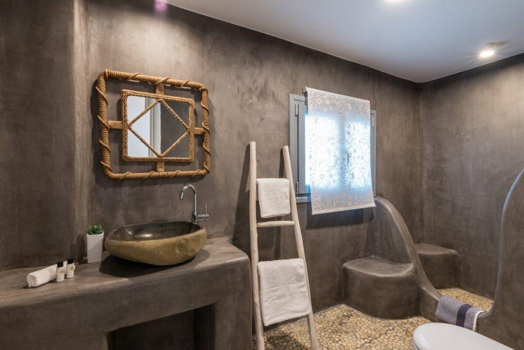 grey wall bathroom with unique designed mirror