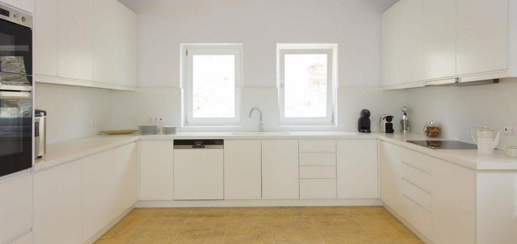 spacious kitchen with white elements and modern technique for cooking delicious meals
