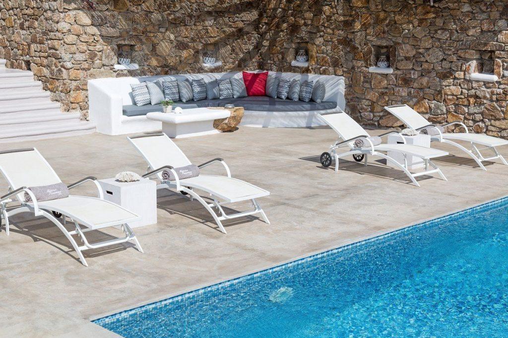 outdoor area with pool and colorful pillows