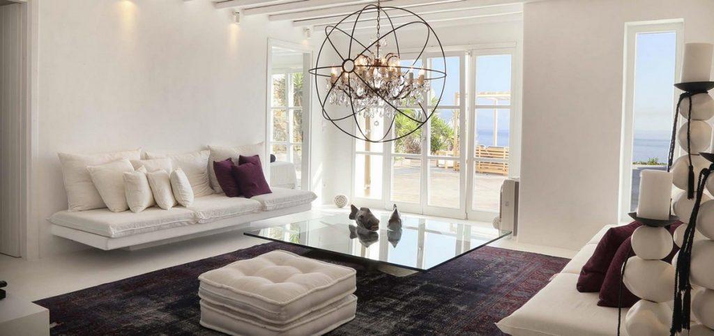 modern designed living area with intriguing chandelier and sea view