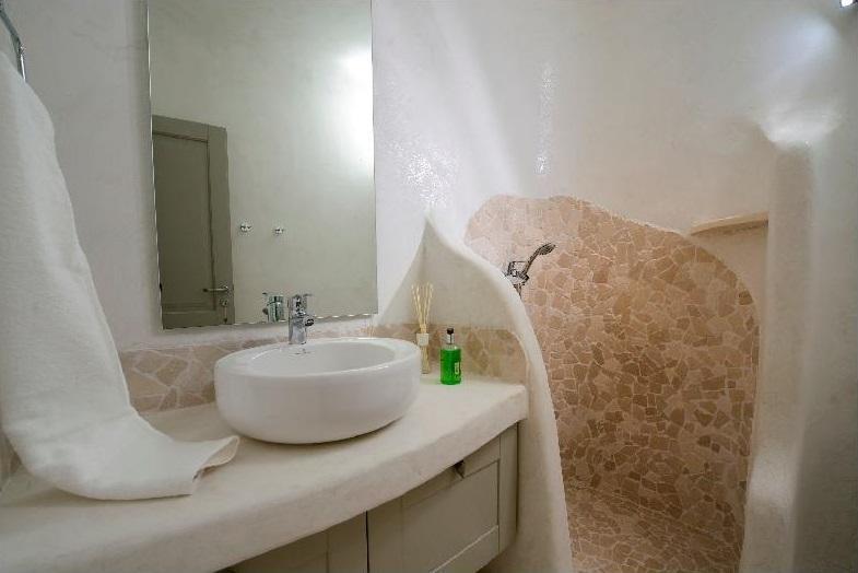 bathroom with stone shower and towel