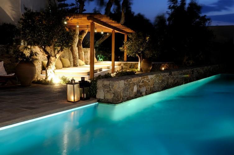 pool area with candles next to pool for romantic night