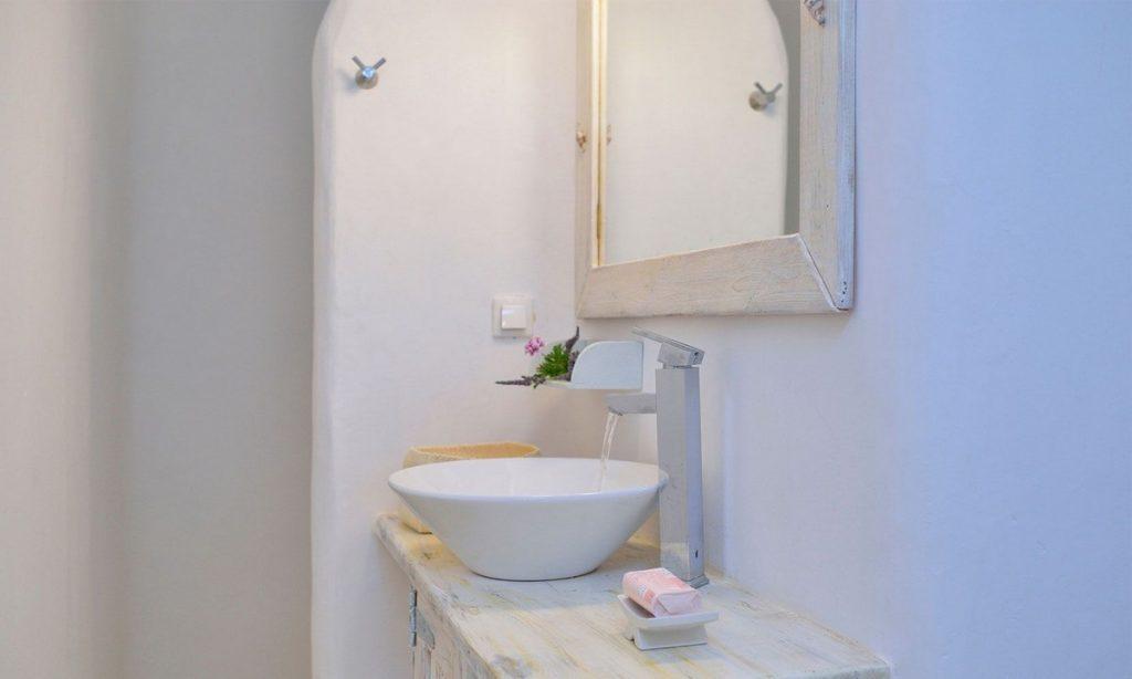simply designed bathroom with shower and ceramic sink