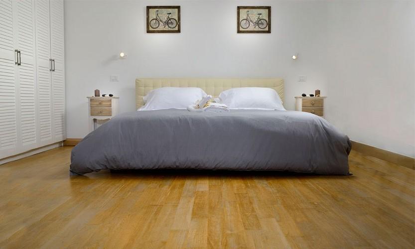 bedroom with wooden floor and comfort huge bed