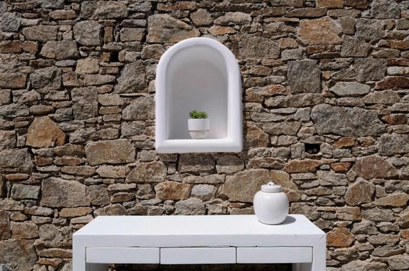 outside white table and ceramic window shaped decoration with plant
