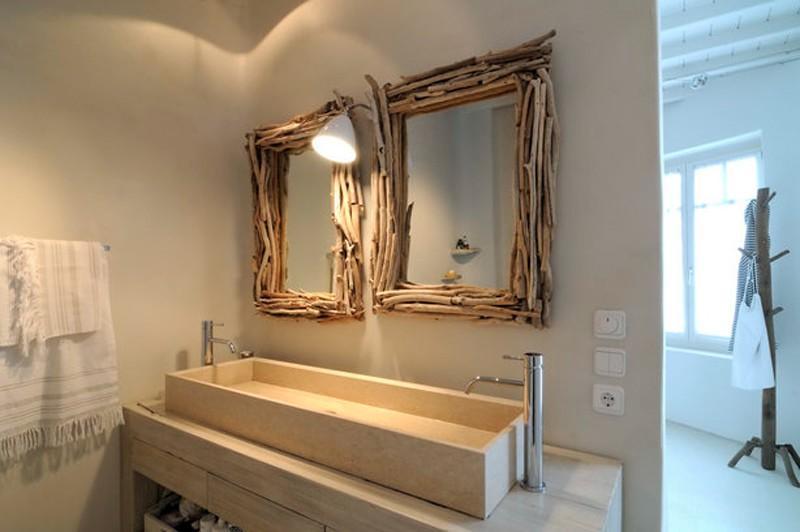 lamp lighted bathroom with two big mirrors with wooden frame and extensive ceramic sink