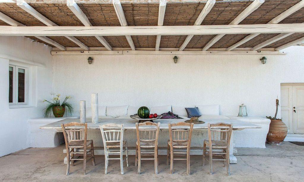outdoor dining area with huge wooden table and bench