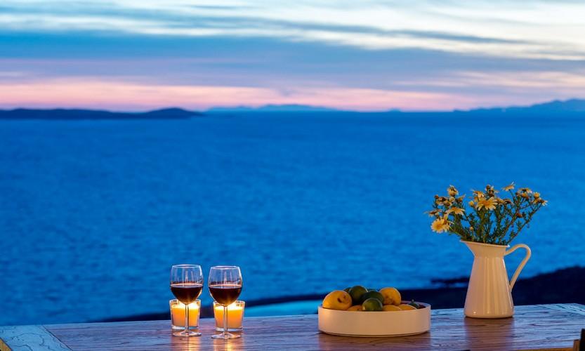 Villa_Apollo_16.jpg Choulakia Mykonos Outdoor, vase, glass, vine, table, candle, fruits, sea, sky, horizon