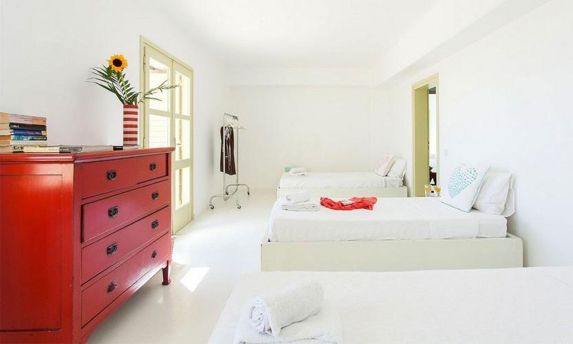 Villa_Cynthia_33.jpg Fanari Mykonos 6th Bedroom, bed, pillows, cabinet, book, flowers, vase