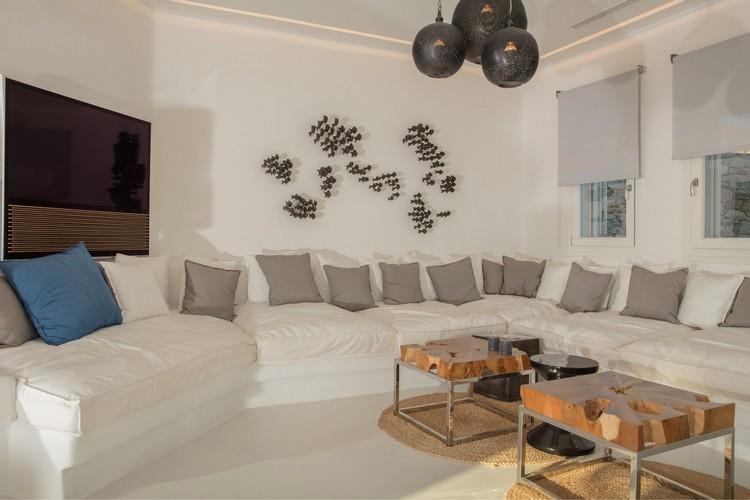 Villa_Nika_13.jpg Tourlos Mykonos Living area, bed, pillows, flat screen tv, table