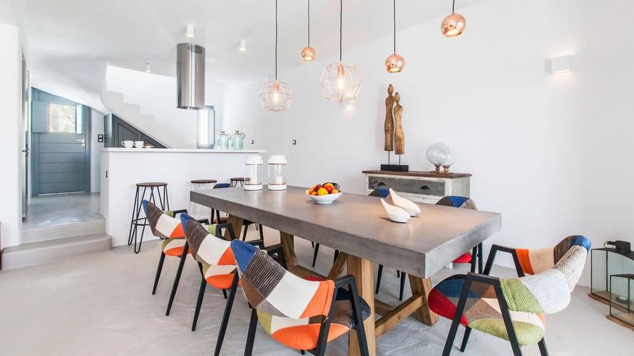 dining area with unique colored chairs and huge ceramic table
