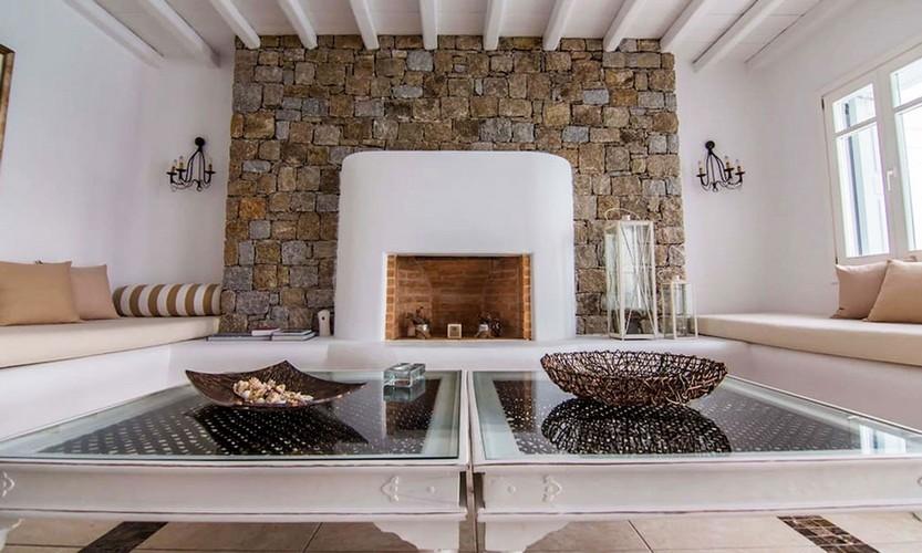 Villa_Star1_11.jpg Kanalia Mykonos Living area, fire place, table, vase, pillows
