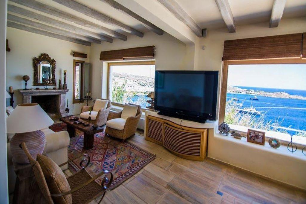 Villa Felicia Agios Lazaros Mykonos, living room, mirror, flat screen TV, armchairs, sofa, lamp, picture, fireplace