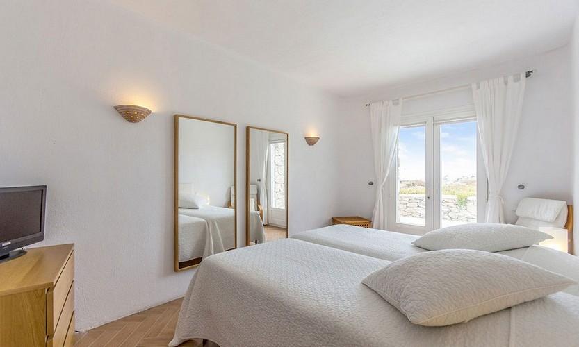 Villa_Zephyr2_20.jpg Super Paradise Mykonos 3rd Bedroom, bed, pillows, cabinet, mirror