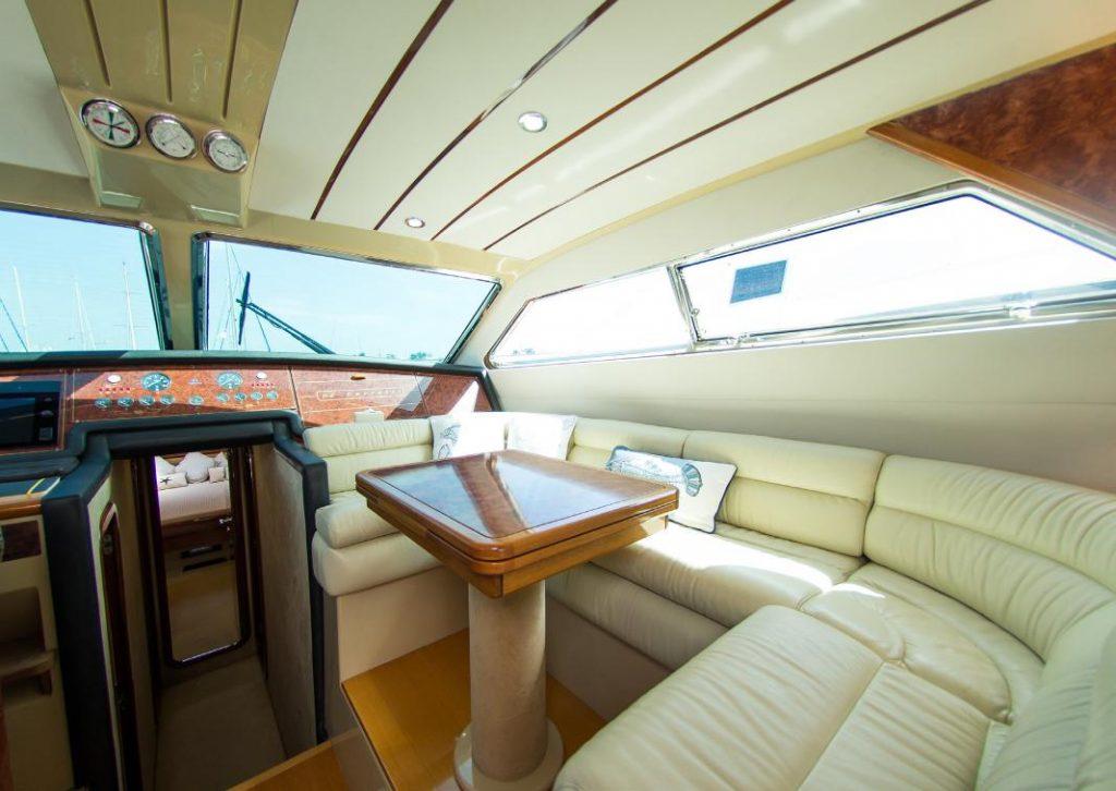 Yacht Baia Azura Mykonos, yacht interior, table, sofa, pillows