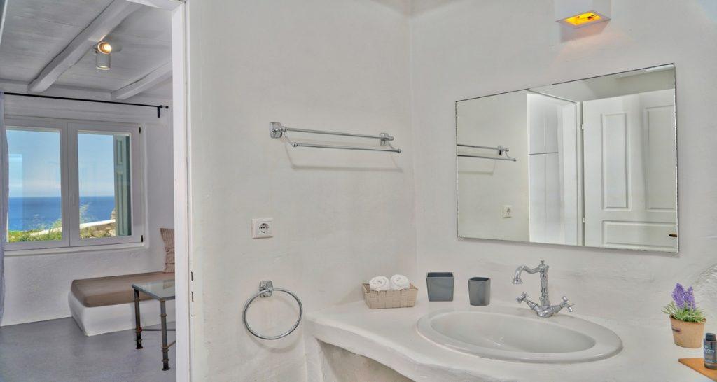 bathroom with towel rack and wall lamp