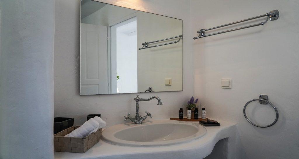 simply designed bathroom with towel rack and sink