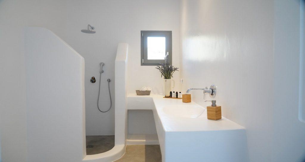bathroom with shower and white stone sink