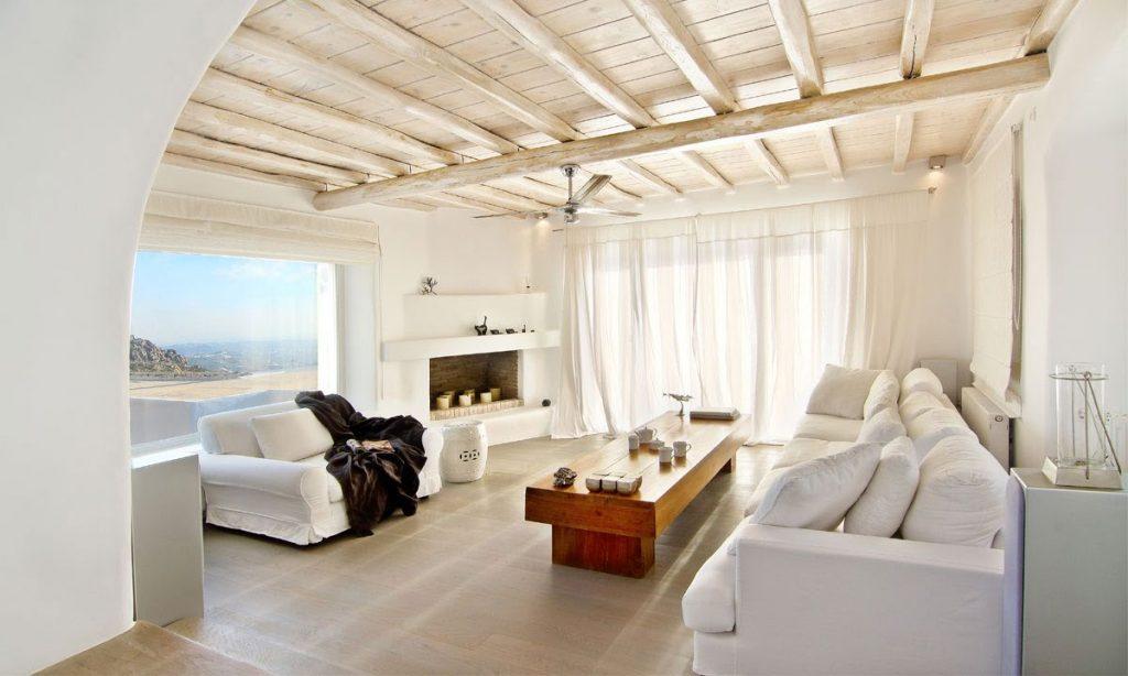 Villa Gianna, Fanari, Mykonos, Sofa, Pillows, Pictures, Lamps, Windows, White walls, Sea view, Sky, Fireplace