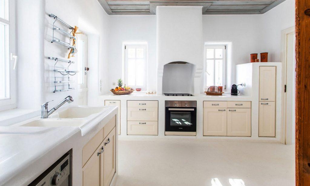 modern designed kitchen with beige doors and ceramic sink