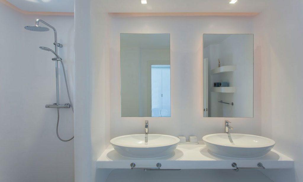 bathroom with wall lamps and shower