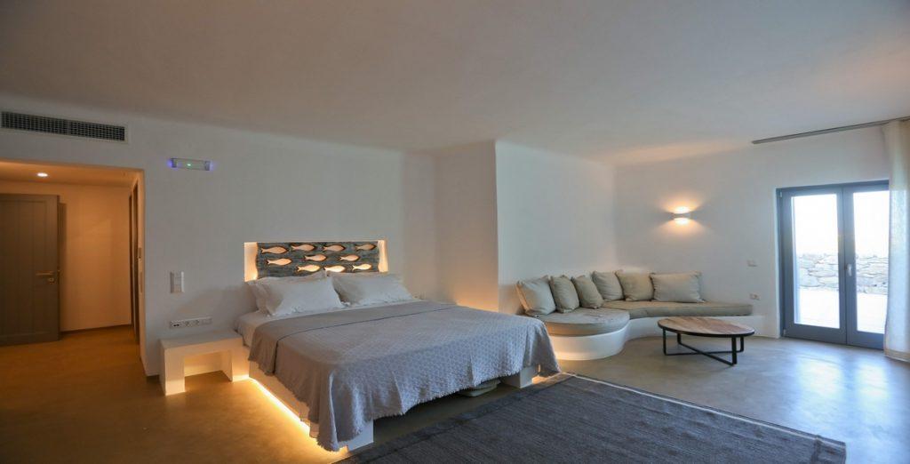 Villa-Ragnar_15.jpg Kalafatis Mykonos, 2nd bedroom, king size bed, sofa, pillows, table, nightstand, lights, curtain