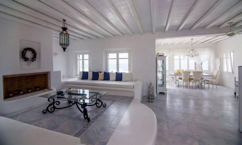 Villa_Eli_15.jpg Agios Ioannis Mykonos Living area, fireplace, table, bench, pillows, lamp