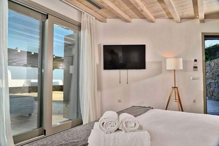white wall bedroom with direct access to the balcony