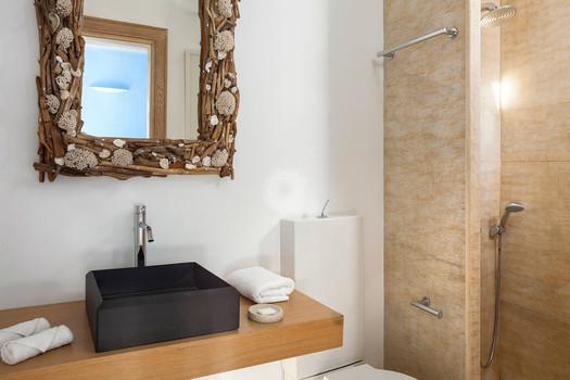 Villa_Jolly_09.jpg Agios Lazaros Mykonos 1st Bathroom, washstand, mirror, shower, towels, soap