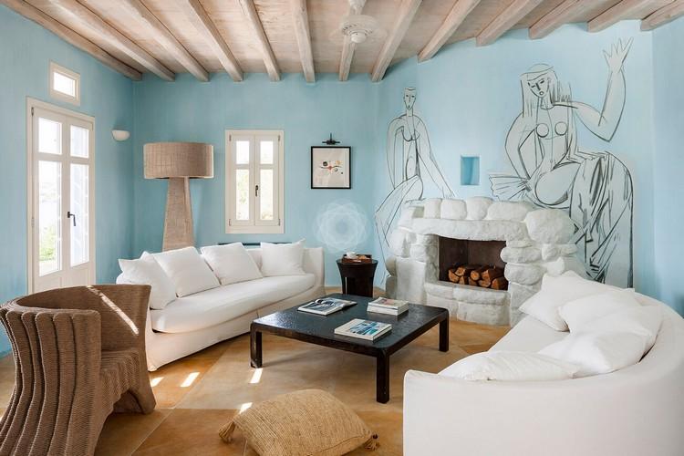 Villa_Jolly_13.jpg Agios Lazaros Mykonos Living area, fireplace, wood, bed, pillows, book, table