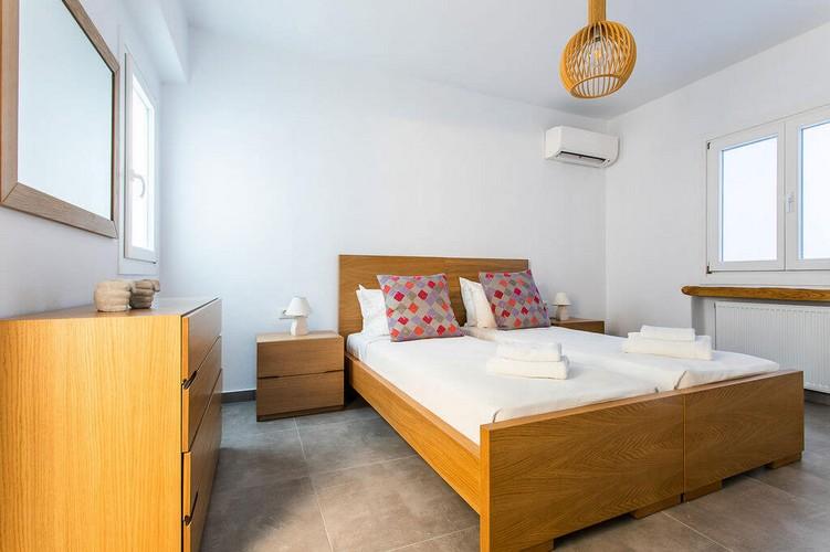 Villa_Kim_11.jpg Agios Stefanos Mykonos 1st Bedroom, bed, pillows, towels, air condition, cabinet, mirror