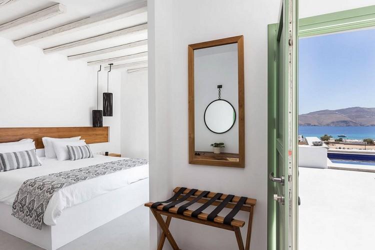 Villa_Lulu_06.jpg Panormos Mykonos 1st Bedroom, mirror, chair, bed, pillows, door