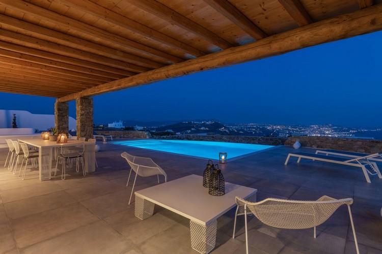Villa_Madona_03.jpg Tourlos Mykonos Outdoor Dining area, table, chairs, lamp, pool, climbers