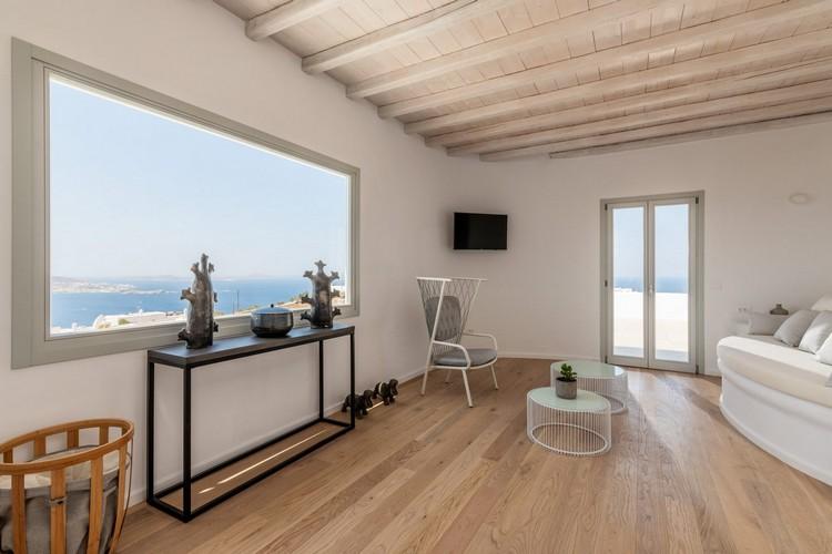 Villa_Madona_19.jpg Tourlos Mykonos Living area, flat screen tv, table, chairs, sea, sky, windows, horizon