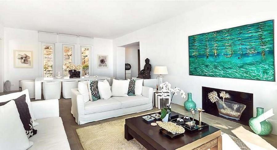 Villa_Nadine_09.jpg Houlakia Mykonos Living area, flat screen tv, paint, table, vase, bed, carpet, chairs