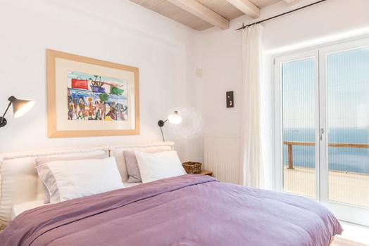 Villa_Pamella_06.jpg Pouli Mykonos 2nd Bedroom, double bed, pillows, paint, lamp, night table, curtains