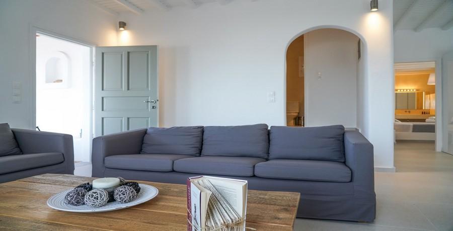 Villa_Sofy_13.jpg Kalafatis Mykonos Living area, bed, book, pillows, door, lamp
