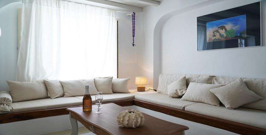 Villa_Tessa_11.jpg Agios Ioannis Mykonos Living area, bed, pillows, paint, curtains, glass, vine, bottle