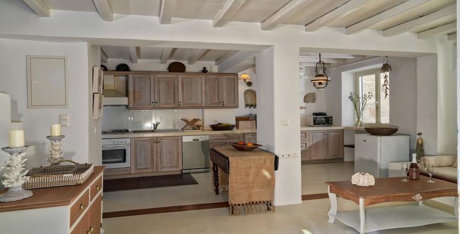 Villa_Tessa_12.jpg Agios Ioannis Mykonos Kitchen, table, vase, fruits, candle, cabinet, oven, microwave