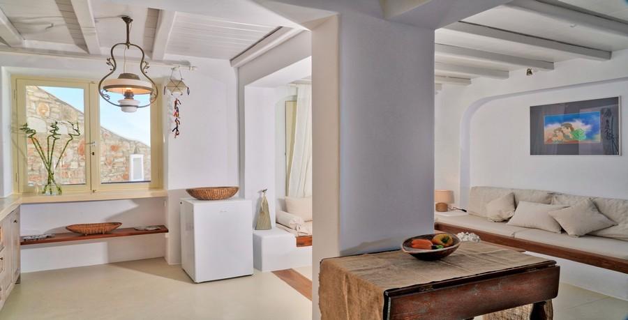 Villa_Tessa_13.jpg Agios Ioannis Mykonos Living area, lamp, fridge, table, bed, pillows, paint