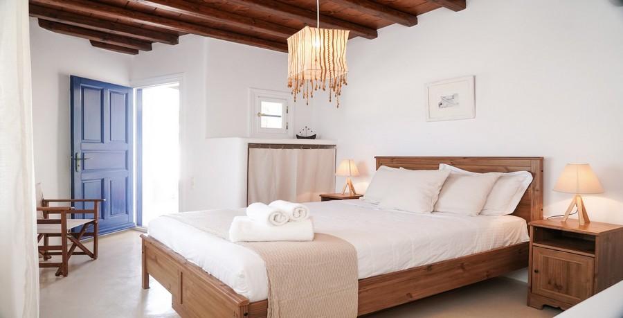 Villa_Tessa_22.jpg Agios Ioannis Mykonos 1st Bedroom, bed, pillows, lamp, night table, door
